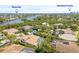 Stunning aerial view of the home with a tile roof, pool, and glimpses of Tampa Bay and Downtown St. Pete at 1220 Darlington Oak Ne Cir, St Petersburg, FL 33703