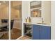 Outdoor bar area with blue cabinetry, a built-in beverage fridge, and convenient sink at 1220 Darlington Oak Ne Cir, St Petersburg, FL 33703
