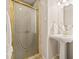 Bathroom featuring a glass door shower and sleek pedestal sink at 1220 Darlington Oak Ne Cir, St Petersburg, FL 33703