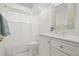 Well-lit bathroom featuring a single sink vanity with modern fixtures and a tiled mirror surround at 1220 Darlington Oak Ne Cir, St Petersburg, FL 33703