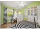 Cheerful bedroom with lime walls, a ceiling fan, and natural light from the window at 1220 Darlington Oak Ne Cir, St Petersburg, FL 33703