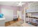 Bright bedroom featuring white walls and doors, a ceiling fan, wood floors, and a unique bunkbed at 1220 Darlington Oak Ne Cir, St Petersburg, FL 33703