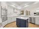 Charming kitchen with stainless steel appliances, an island, white cabinetry, and a decorative backsplash at 1220 Darlington Oak Ne Cir, St Petersburg, FL 33703
