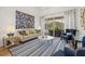 Bright living room with elegant furnishings, stylish rug, and sliding glass doors to outdoor dining area at 1220 Darlington Oak Ne Cir, St Petersburg, FL 33703