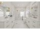 Luxurious main bathroom with a soaking tub, glass enclosed shower, and dual vanities with brass fixtures at 1220 Darlington Oak Ne Cir, St Petersburg, FL 33703