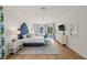 Bright main bedroom featuring a large window with seating area overlooking the pool and a plush, tufted headboard at 1220 Darlington Oak Ne Cir, St Petersburg, FL 33703