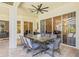 Covered outdoor dining area with a large table and chairs, offering shade and style at 1220 Darlington Oak Ne Cir, St Petersburg, FL 33703
