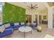 Stylish outdoor area with living wall, comfortable seating, and modern ceiling fan at 1220 Darlington Oak Ne Cir, St Petersburg, FL 33703