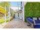 Relaxing screened patio with pavers, seating, an outdoor kitchen and a lush green wall at 1220 Darlington Oak Ne Cir, St Petersburg, FL 33703