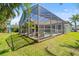 Inviting screened pool area with lounge chairs and tropical plants in a well-kept backyard at 1220 Darlington Oak Ne Cir, St Petersburg, FL 33703