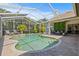 Covered pool area featuring palm trees and green wall offering a serene outdoor retreat at 1220 Darlington Oak Ne Cir, St Petersburg, FL 33703