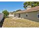 Exterior view of a backyard featuring a patio set and fire pit on a dry lawn at 12532 115Th St, Largo, FL 33778