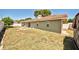 Exterior view of a backyard featuring a patio set and fire pit on a dry lawn at 12532 115Th St, Largo, FL 33778