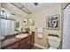 A vintage bathroom features wallpaper, a vanity, and a shower with seahorse-themed curtains at 12532 115Th St, Largo, FL 33778