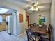Dining room with tiled floor, ceiling fan and wooden table with 4 chairs set near kitchen with appliances at 12532 115Th St, Largo, FL 33778