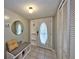 Welcoming entryway features a bench with storage, a round mirror, and a storm door for added protection at 12532 115Th St, Largo, FL 33778