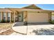 Home's front entrance with stone accents, covered porch, and attached two-car garage at 12532 115Th St, Largo, FL 33778