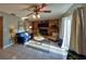 Comfortable living room with a stone fireplace, ceiling fan, and access to the outdoor space at 12532 115Th St, Largo, FL 33778