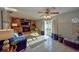 Open living room boasts a stone fireplace, a ceiling fan, and sliding glass doors to the outdoors at 12532 115Th St, Largo, FL 33778
