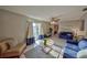 Spacious living room with tile floors, sliding glass doors to the backyard, and a comfortable seating area at 12532 115Th St, Largo, FL 33778