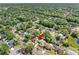 Expansive aerial view of a lovely neighborhood with mature trees and beautiful homes with private backyard pools at 15307 Summerwind Dr, Tampa, FL 33624