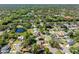Aerial shot capturing houses amidst nature, complemented with a serene lake, and lush green trees at 15307 Summerwind Dr, Tampa, FL 33624