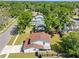 This is an aerial view of the home showcasing its brown roof in a neighborhood with mature trees at 15307 Summerwind Dr, Tampa, FL 33624