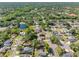 Aerial view showcases a peaceful neighborhood dotted with houses and lush greenery, with a small lake at 15307 Summerwind Dr, Tampa, FL 33624