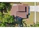 Aerial view of a home with a brown roof, lawn, and privacy fence in a quiet neighborhood at 15307 Summerwind Dr, Tampa, FL 33624