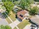 This is an aerial view of the home showcasing its brown roof in a neighborhood with mature trees and manicured lawns at 15307 Summerwind Dr, Tampa, FL 33624