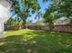 Spacious backyard featuring beautiful grass and a view of the home's fence line at 15307 Summerwind Dr, Tampa, FL 33624