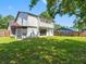 Spacious backyard featuring beautiful grass and a view of the screened in back porch and large window at 15307 Summerwind Dr, Tampa, FL 33624