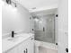 This bathroom features a modern vanity, toilet, and a glass-enclosed shower with gray tile at 15307 Summerwind Dr, Tampa, FL 33624