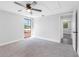 This is a bright bedroom with a large window and neutral walls and carpet at 15307 Summerwind Dr, Tampa, FL 33624