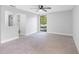 Well lit bedroom featuring a ceiling fan, neutral carpet, and a large window at 15307 Summerwind Dr, Tampa, FL 33624