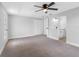 Spacious bedroom featuring neutral carpet, a ceiling fan, bar, and closet at 15307 Summerwind Dr, Tampa, FL 33624