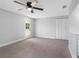Bedroom featuring neutral carpet, a ceiling fan, exterior door, and closet at 15307 Summerwind Dr, Tampa, FL 33624