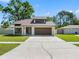 Beautiful one story home with a two car garage, well-kept lawn, and modern architectural style at 15307 Summerwind Dr, Tampa, FL 33624
