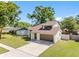 Charming home with a well-groomed lawn, modern door, and a spacious two-car garage, great for families at 15307 Summerwind Dr, Tampa, FL 33624