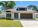 Charming single-Gathering home with modern door, attached garage and well manicured front lawn at 15307 Summerwind Dr, Tampa, FL 33624