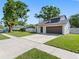 Attractive home with a modern touch featuring a neat lawn, sleek door, and two-car garage for convenience at 15307 Summerwind Dr, Tampa, FL 33624