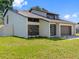 Well-kept home featuring a modern architectural style, two-car garage and lush green lawn at 15307 Summerwind Dr, Tampa, FL 33624