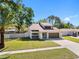 Eye-catching home with tidy lawn and two-car garage, offering a comfortable and modern lifestyle at 15307 Summerwind Dr, Tampa, FL 33624