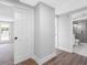 Open hallway featuring access to the bedroom and updated bathroom with glass shower at 15307 Summerwind Dr, Tampa, FL 33624