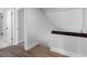 Bright hallway with white trim, gray walls, wood floors, and doorways to other rooms at 15307 Summerwind Dr, Tampa, FL 33624