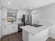 Modern kitchen featuring white cabinets, stainless steel appliances, and a quartz countertop island at 15307 Summerwind Dr, Tampa, FL 33624