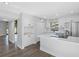 Bright kitchen featuring white cabinets, stainless steel appliances, and a center island with quartz countertops at 15307 Summerwind Dr, Tampa, FL 33624