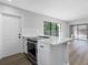 Kitchen island featuring an electric range in the island top and a stainless steel oven below at 15307 Summerwind Dr, Tampa, FL 33624