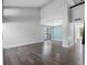 Open-concept living room with high ceilings, laminate floors, and large windows, freshly painted at 15307 Summerwind Dr, Tampa, FL 33624