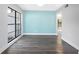 Inviting living room with blue accent wall, laminate floors, and large windows, freshly painted at 15307 Summerwind Dr, Tampa, FL 33624
